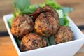 Spicy mince pork balls with salad in a white plate