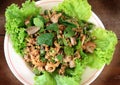 Spicy minced pork put liver, chitterlings, shallot in dish on wood table