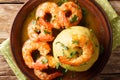 Spicy mofongo with plantains, garlic and chicharron served with shrimp and broth close-up on the table. horizontal top view Royalty Free Stock Photo