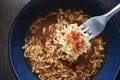 Spicy noodle soup on fork in a bowl. Instant noodles soup. Royalty Free Stock Photo