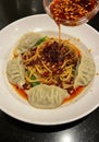 Spicy Noodles with Dumplings and Chilli Oil Royalty Free Stock Photo