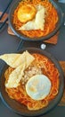 spicy noodles with half boiled egg and dumplings Royalty Free Stock Photo