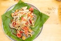 Spicy Papaya Salad and raw prawn spice on banana leaf