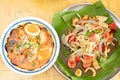 Spicy Papaya Salad raw prawn spice on banana leafand Tomyum Royalty Free Stock Photo