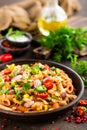 Spicy pasta penne bolognese with vegetables, beans, chili and cheese in tomato sauce Royalty Free Stock Photo