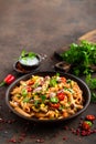 Spicy pasta penne bolognese with vegetables, beans, chili and cheese in tomato sauce Royalty Free Stock Photo