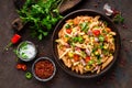 Spicy pasta penne bolognese with vegetables, beans, chili and cheese in tomato sauce