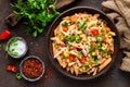 Spicy pasta penne bolognese with vegetables, beans, chili and cheese in tomato sauce Royalty Free Stock Photo