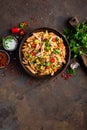 Spicy pasta penne bolognese with vegetables, beans, chili and cheese in tomato sauce Royalty Free Stock Photo