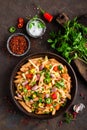 Spicy pasta penne bolognese with vegetables, beans, chili and cheese in tomato sauce Royalty Free Stock Photo