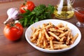 Spicy pasta penne bolognese with vegetables, chili and cheese in tomato sauce. Royalty Free Stock Photo