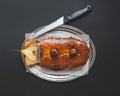 Spicy pear cake with caramel topping on a silver dish on black