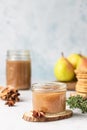 Spicy pear jam in glass jar, fresh pears, spices cinnamon and anise and thyme.