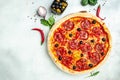 Spicy pepperoni pizza, Tomato sauce, pepper, Italian pizza on light table background. Restaurant menu, dieting, cookbook recipe Royalty Free Stock Photo