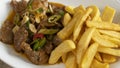 Spicy plate pork meat with french fries and garlic