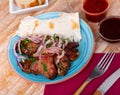 Spicy pork shashlik with onion, lavash and sauces Royalty Free Stock Photo