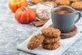 Spicy pumpkin and oatmeal cookies with cup of coffee, horizontal, copy space