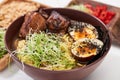 Spicy ramen with beef, egg and microgreen in bowl Royalty Free Stock Photo