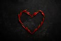 Spicy red chili pepper in the shape of a heart on a dark stone background Royalty Free Stock Photo