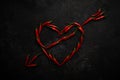 Spicy red chili pepper in the shape of a heart on a dark stone background Royalty Free Stock Photo