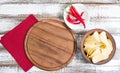 Spicy red chilli potato chips and empty board on a wooden table Royalty Free Stock Photo