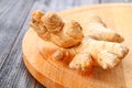 Spicy root of ginger on a wooden table. Royalty Free Stock Photo