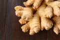 Spicy root of ginger on a wooden table. Royalty Free Stock Photo