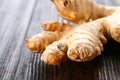 Spicy root of ginger on a wooden table. Royalty Free Stock Photo