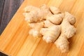 Spicy root of ginger on a wooden table. Royalty Free Stock Photo