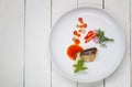 Spicy Salad with canned sardine fish in white dish on wooden floor Royalty Free Stock Photo