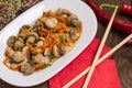 Spicy salad of mushrooms and carrots in Korean. Top view. Close-up. Wooden rustic background. Royalty Free Stock Photo