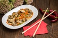 Spicy salad of mushrooms and carrots in Korean. Top view. Close-up. Wooden rustic background. Royalty Free Stock Photo