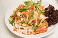 Spicy salad with squid onion, green herbs and tomato