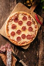 Spicy salami or pepperoni pizza with chili