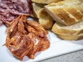 Spicy salami slices on a serving platter in close-up view