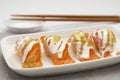 Spicy salmon sushi with hot seafood dip