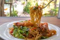 Spicy seafood spaghetti pasta or Spaghetti tom yum with a folk Royalty Free Stock Photo