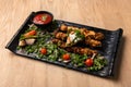 Spicy Shish Tawook with salad and tomato sauce served in dish isolated on table top view of arabian food