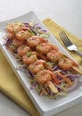 Spicy shrimp skewers on coleslaw salad