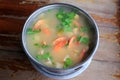 Spicy shrimp soup or Tom yum goong hot and sour in pot on wood table. Thai traditional cuisine Royalty Free Stock Photo