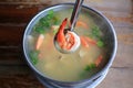 Spicy shrimp soup or Tom yum goong hot and sour in pot on wood table. Thai traditional cuisine Royalty Free Stock Photo