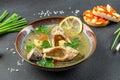 Spicy snake head fish soup ,Thai hot and sour soup call Tom yum on a dark background. top view. copy space for text Royalty Free Stock Photo