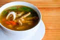 Spicy and sour chicken feet soup Tom Yum in white ceramic bowl on wooden table background, copy space Royalty Free Stock Photo