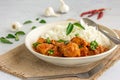 Spicy South Indian Chicken Curry and Rice Garnished with Curry Leaves, Garlic and Chili Peppers, Indian Food Photography
