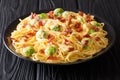 Spicy spaghetti cooked with Brussels sprouts, bacon, garlic with melted creamy cheese close-up on a plate on the table Royalty Free Stock Photo