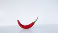 A bent red fresh chili on a white background Royalty Free Stock Photo