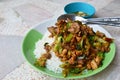 Spicy stir-fried chicken innards with basil leaves on rice Royalty Free Stock Photo