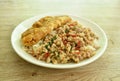 Spicy stir fried chop pork with chili and basil leaf mixed rice topping crispy egg omelette on plate Royalty Free Stock Photo