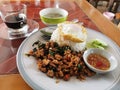 spicy stir fried mint pork with fried egg served with soup and coffee