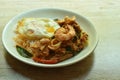 Spicy stir fried shrimp and squid curry eat couple with rice topping egg on plate Royalty Free Stock Photo